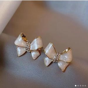 🎀Ivory Swirl Gold Tone Sparkly Bowknot Post Back Stud Earrings💝